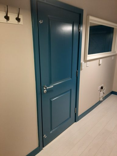 a photo of a blue door and salmon coloured walls
